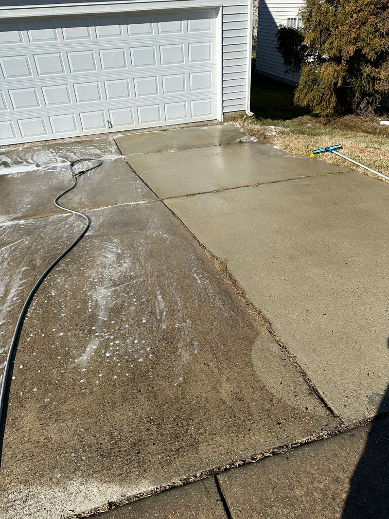 Photo of professional driveway cleaning by pressure washing company in Raleigh